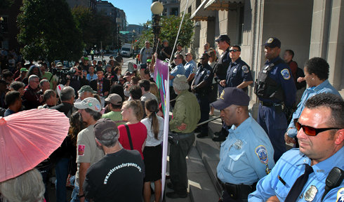 A shot taken of the crowd and the cops from the Chamber's flower patch